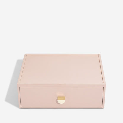 Pink jewelry box with a gold clasp on a white background