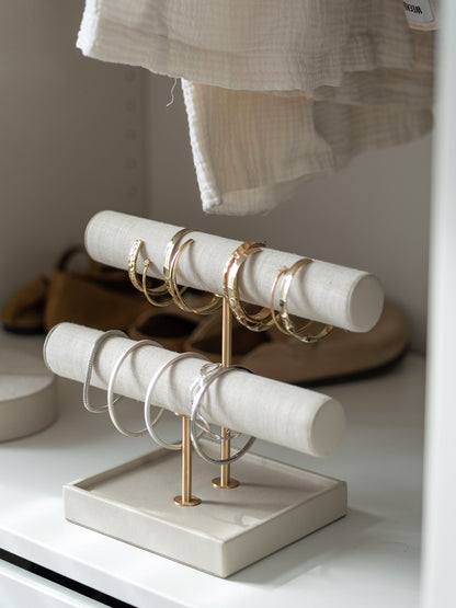 Oatmeal and linen jewelry display stand with rings and bangles on display inside a closet