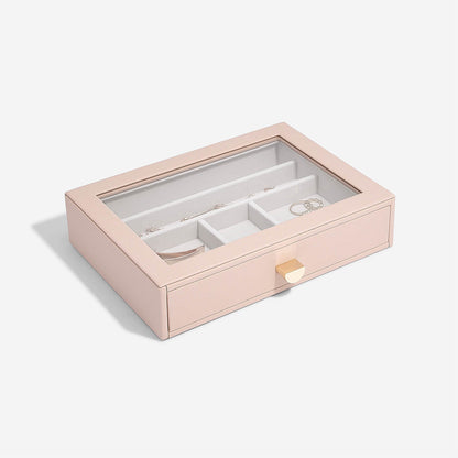 Pink jewelry box with glass top on a white background