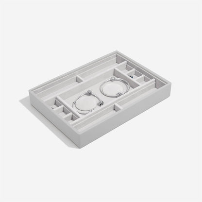 Pebble grey jewelry organizer with two bracelets on a white background