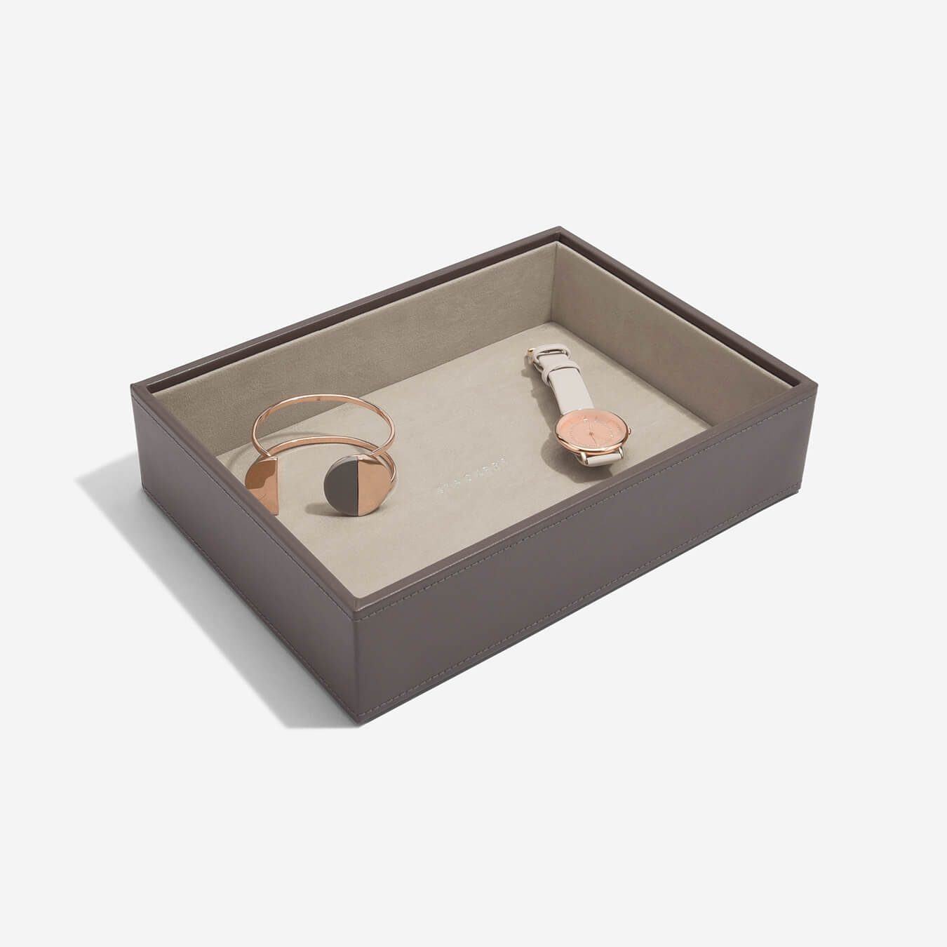Mink jewelry box with a bracelet and watch on a beige background