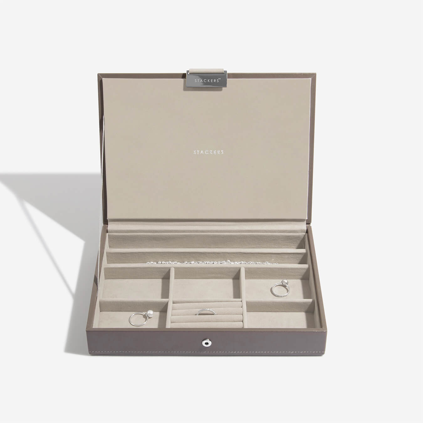 Open jewelry box with compartments on a white background
