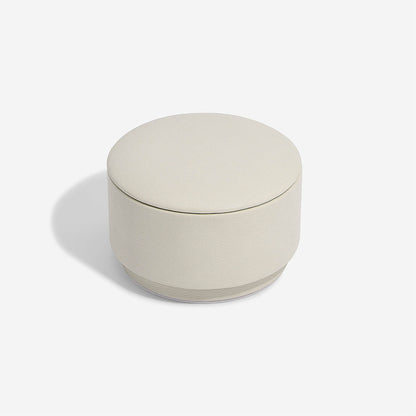 Round oatmeal colour container with a lid on a white background
