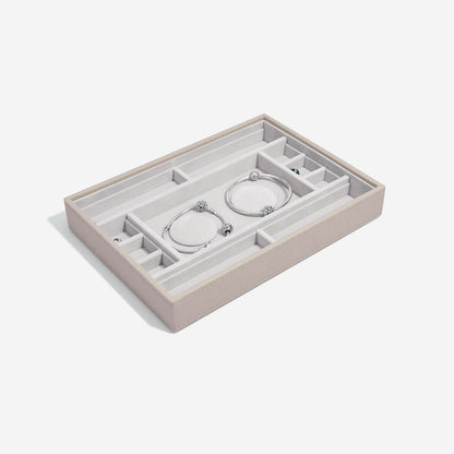 Taupe jewelry tray with compartments on a white background