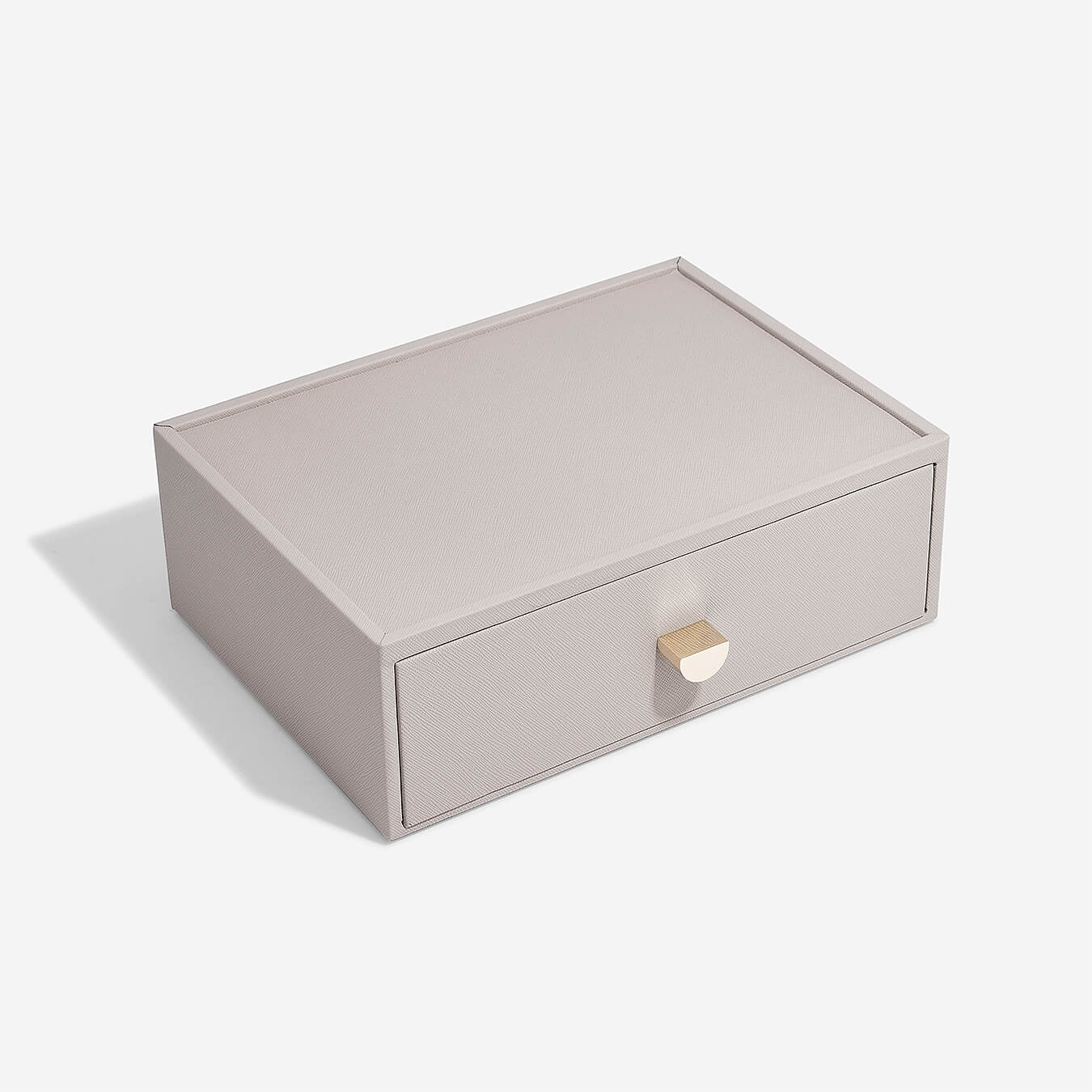 Taupe storage box with a gold handle on a white background